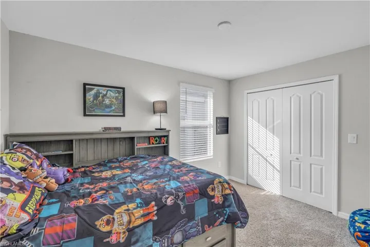 Bedroom with carpet floors and a closet