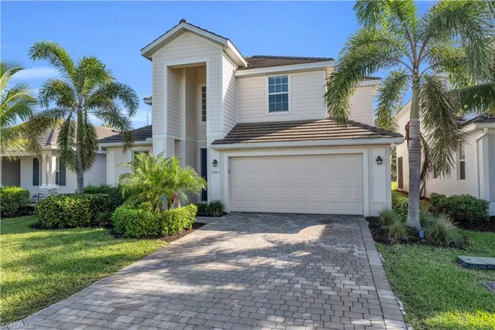 View of front of house with a front yard and a garage