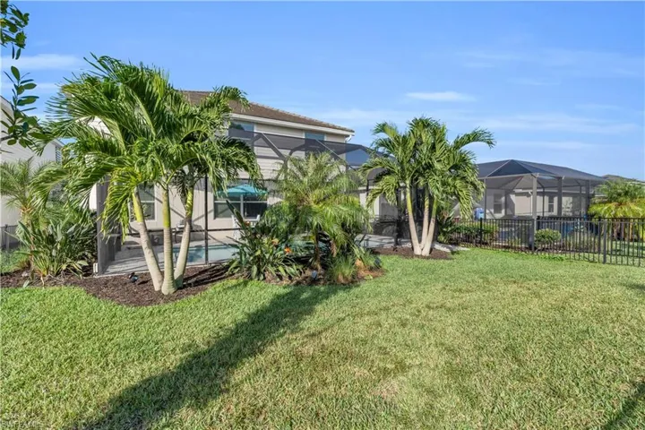 View of yard with a fenced in pool and a lanai