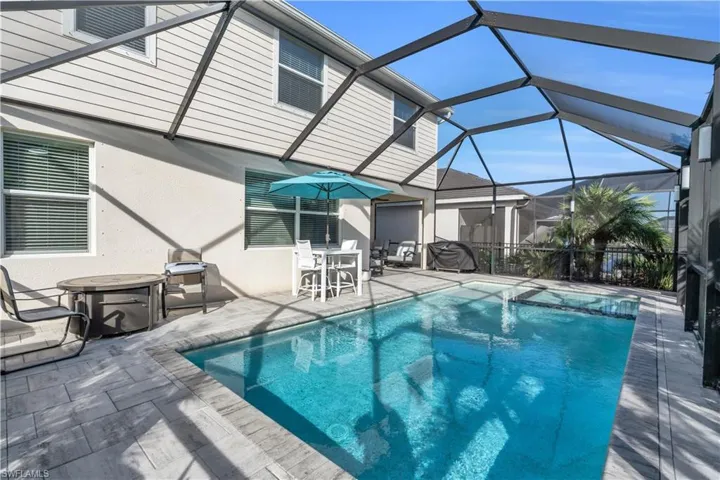 View of swimming pool featuring a patio and a lanai