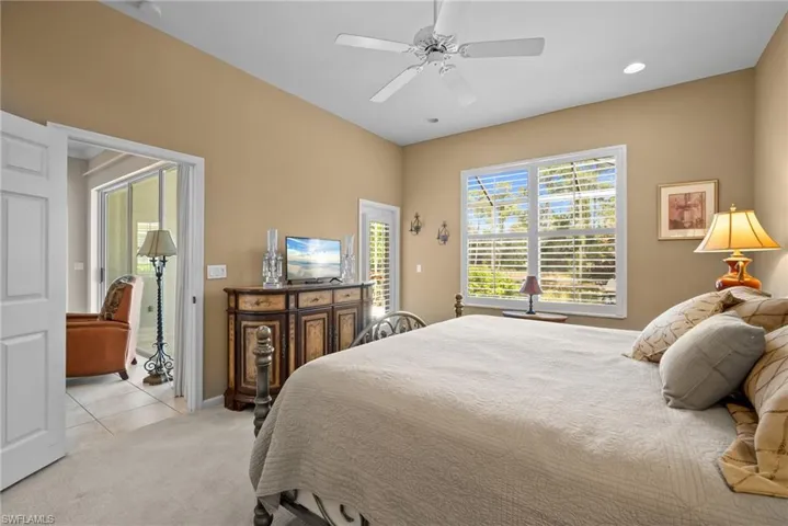 Bedroom with access to exterior, light carpet, a ceiling fan, recessed lighting, and light tile patterned floors