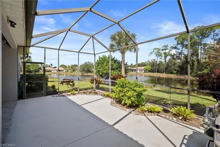 View of patio / terrace featuring glass enclosure, a sunroom, and a water view