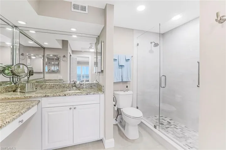 Bathroom featuring vanity, a stall shower, and recessed lighting