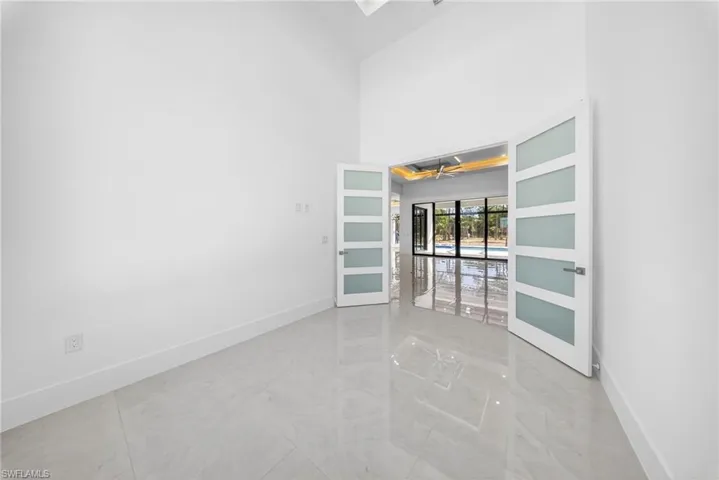 Den/Office space with Modern privacy glass paneled doors.