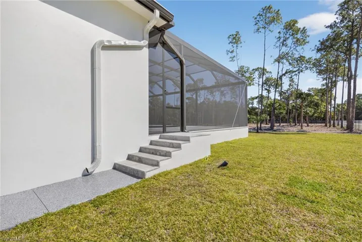 View of grassy yard and marble steps.