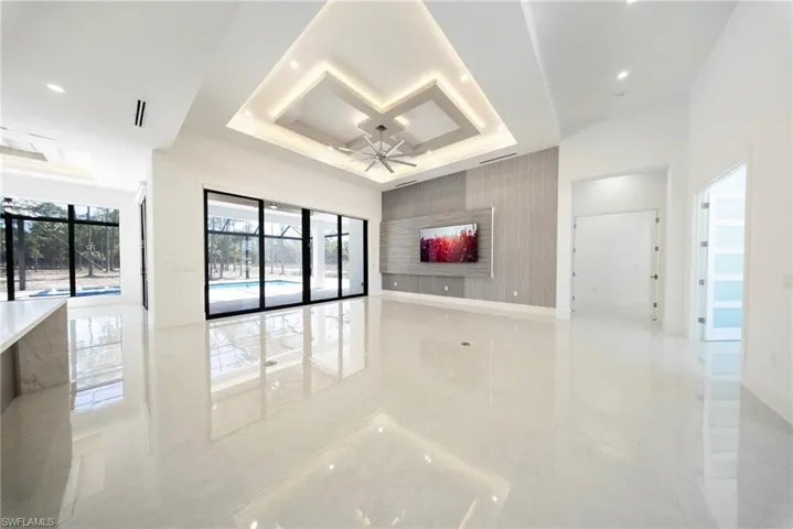 14'4" Ceiling, 10ft sliding doors, TV wall, accent lighting and tile flooring.