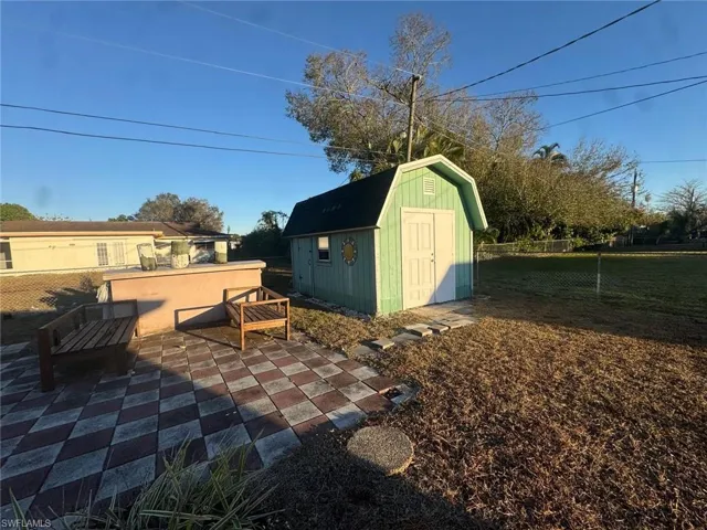 View of shed with a fenced backyard