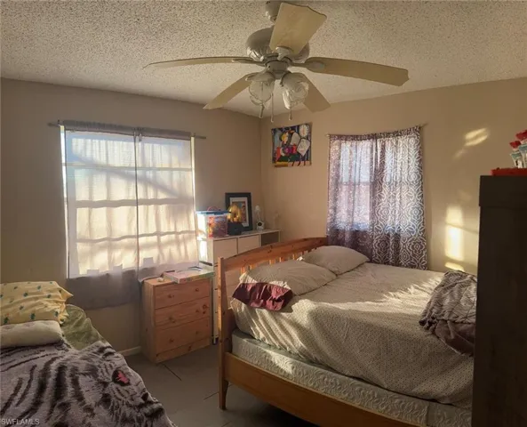 Bedroom featuring a textured ceiling and a ceiling fan