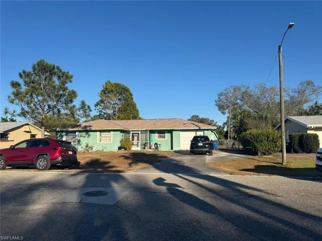 Ranch-style home with asphalt driveway and a garage