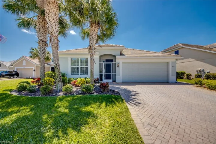 Beautiful front of home with Tile Roof, screened entry