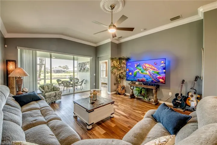 Beautiful Lake Views adorn Family room with Acacia Wood Floors, Crown Molding,
