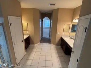 Full bath featuring visible vents, tile patterned floors, vanity, and baseboards