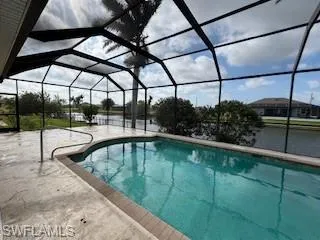 Outdoor pool with a patio area and a lanai