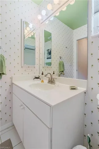 Bathroom with vanity, tile patterned flooring, and toilet