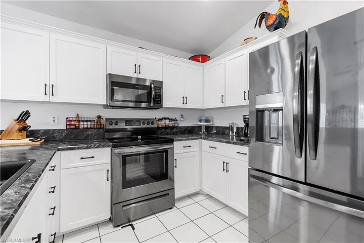 Kitchen with white cabinets, stainless steel appliances