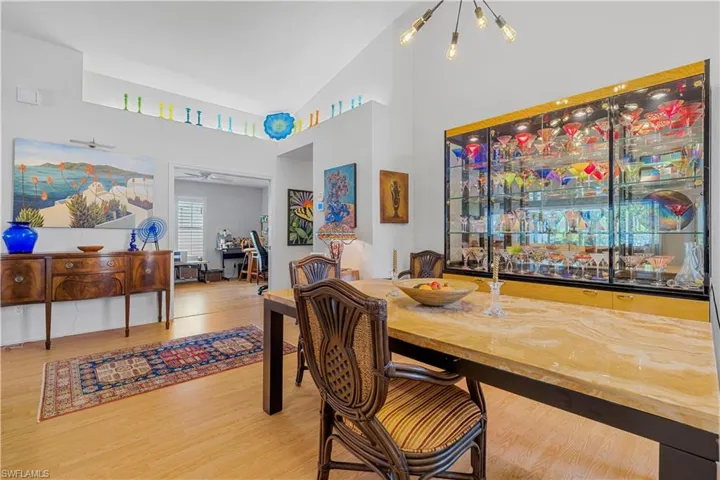 Dining room featuring an inviting chandelier, high vaulted ceiling