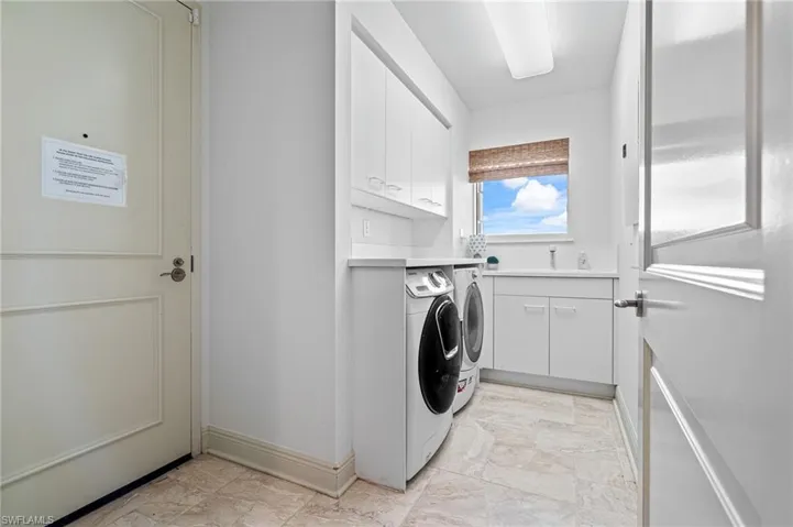 Laundry room featuring cabinet space and washing machine and dryer