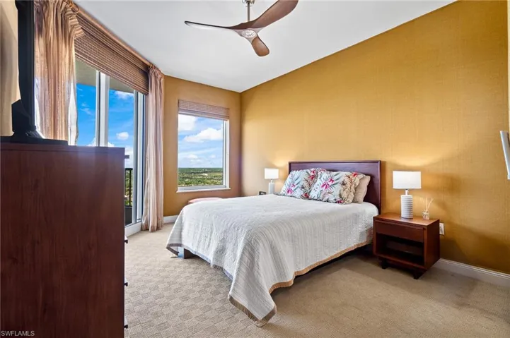 Bedroom with light carpet, access to exterior, and ceiling fan