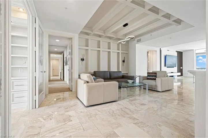Common area featuring beamed ceiling and coffered ceiling
