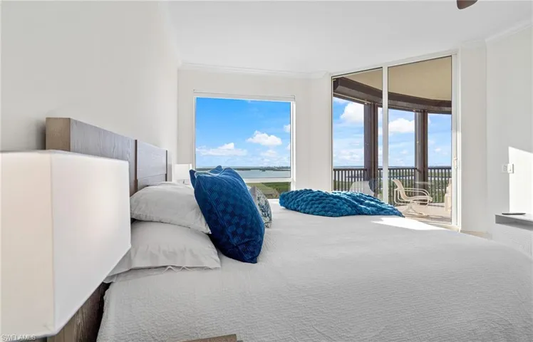Bedroom featuring crown molding and access to outside