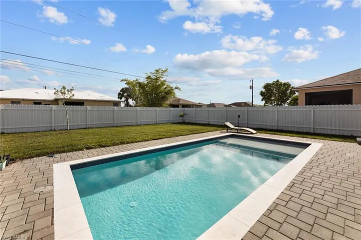 View of pool featuring a lawn