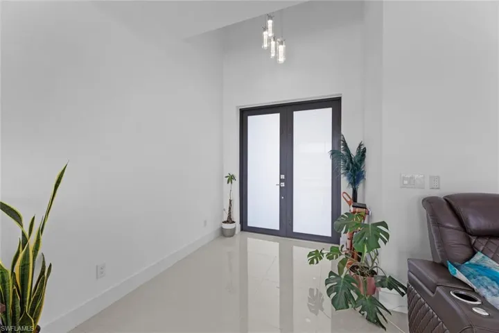 Foyer entrance with tile flooring and french doors