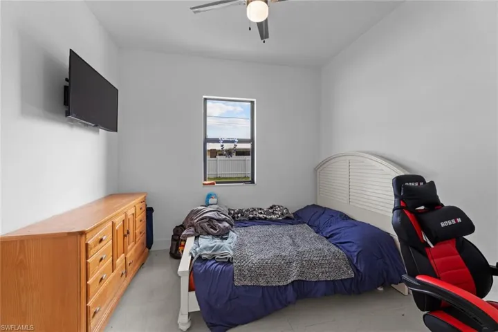 Bedroom featuring ceiling fan and light tile floors