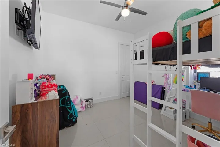 Tiled bedroom with ceiling fan