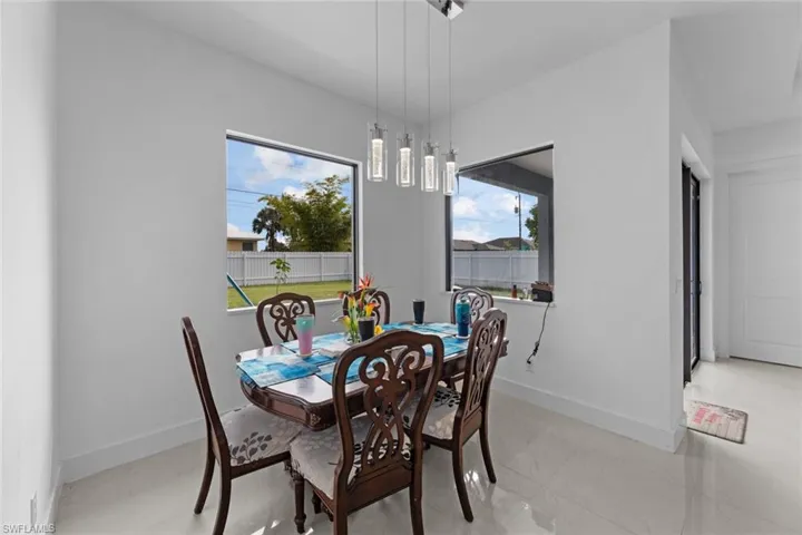 Tiled dining space featuring plenty of natural light