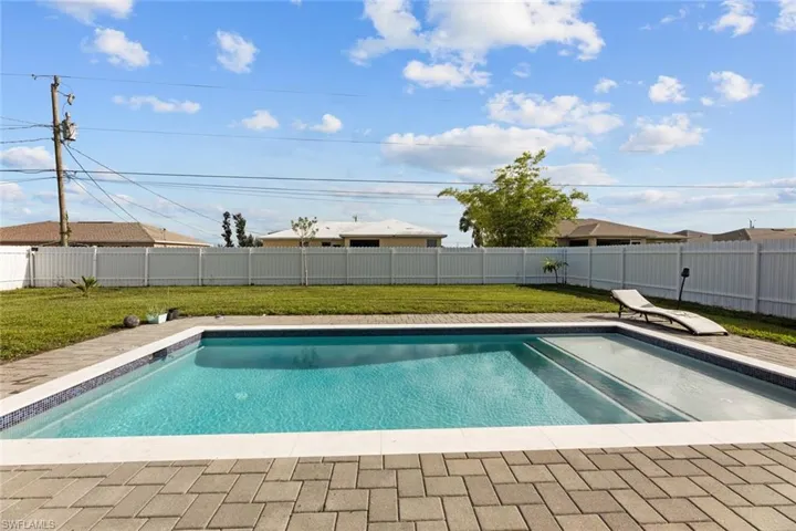 View of swimming pool with a yard