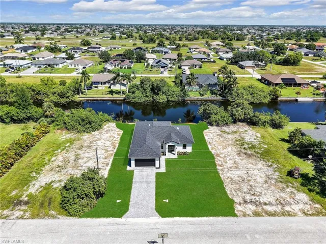 Aerial perspective of suburban area with a nearby body of water