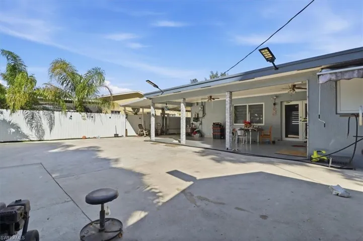 Rear view of house with a ceiling fan and a patio area