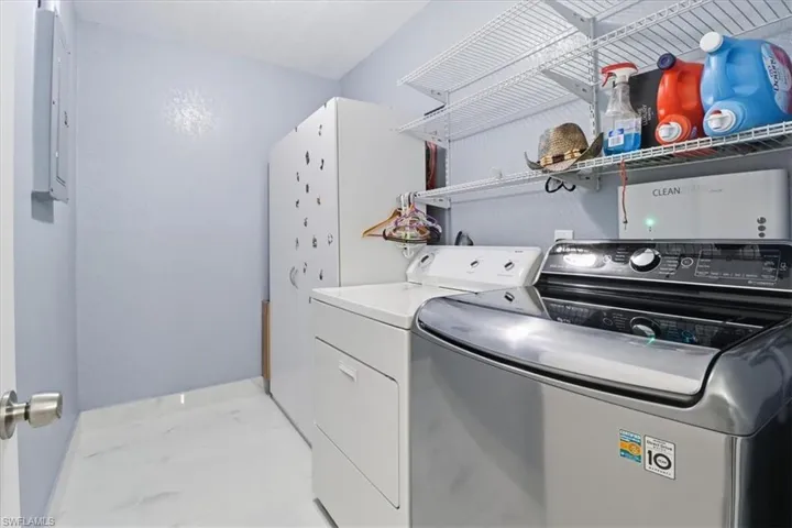 Laundry room featuring separate washer and dryer and electric panel