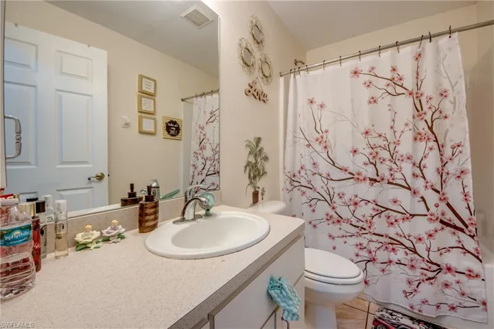 Bathroom featuring tile patterned floors, toilet, and vanity