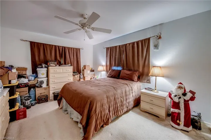 Bedroom featuring light carpet and ceiling fan