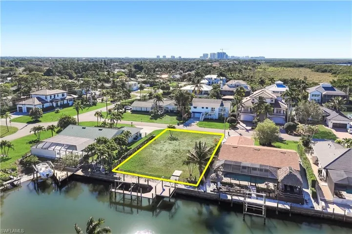 Waterfront lot featuring a cleared building site, existing seawall, and direct water access - Virtually Edited Image