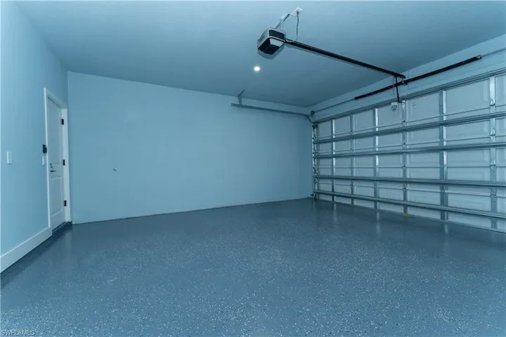 Garage featuring a garage door opener