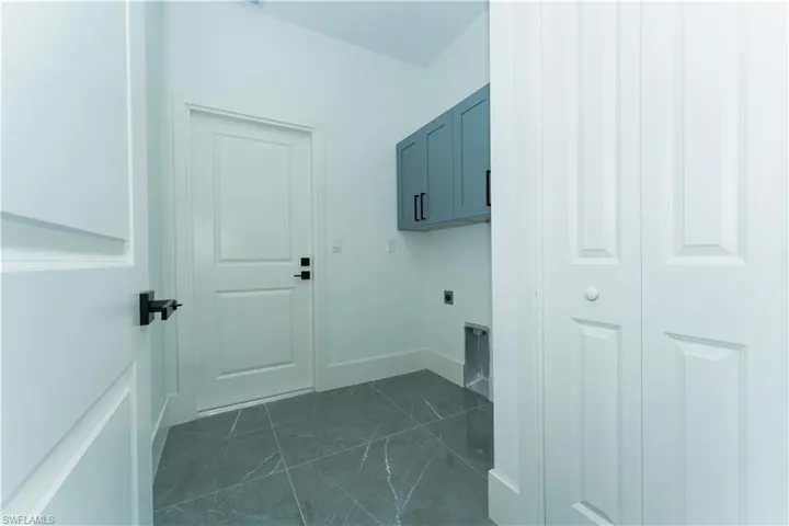 Laundry area featuring cabinet space and electric dryer hookup