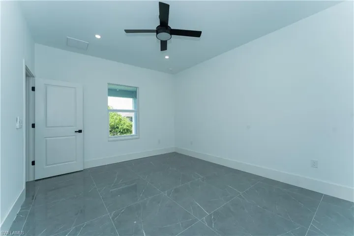 Unfurnished room featuring ceiling fan, baseboards, and recessed lighting