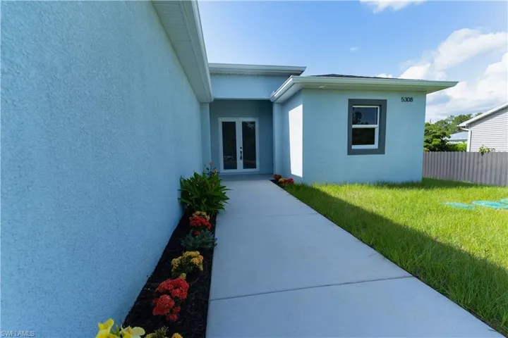 Doorway to property featuring french doors and stucco siding