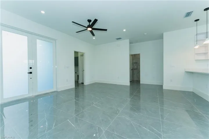 Spare room featuring a ceiling fan, baseboards, recessed lighting, and marble finish floors