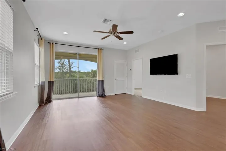 Unfurnished living room with light wood-style flooring, a ceiling fan, and recessed lighting