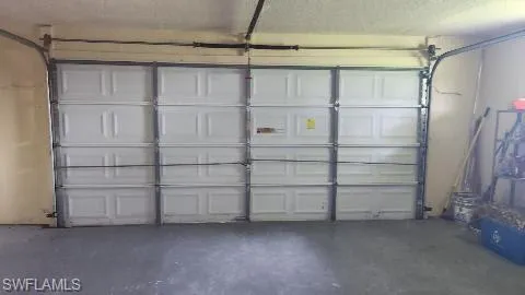 View of garage door and area for shelves on each side.