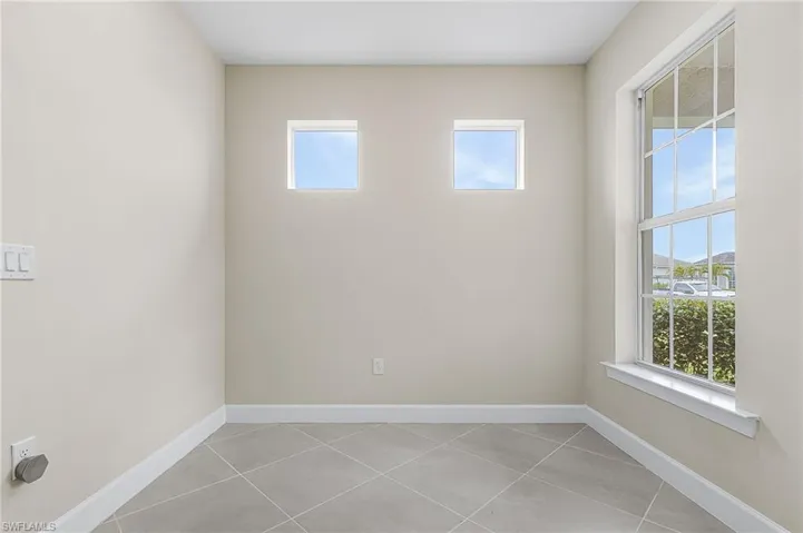 Empty room featuring light tile patterned floors