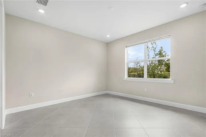 Unfurnished room with recessed lighting and a smoke detector