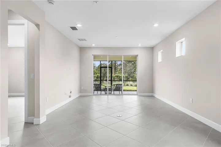 Empty Gathering  room with light tile patterned flooring and recessed lighting