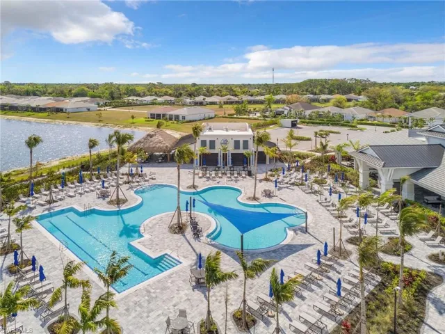 Community pool with a residential view and a patio