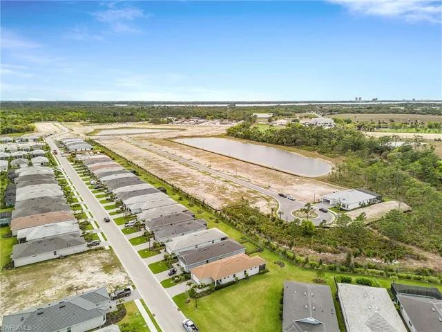 Aerial view of residential area featuring a nearby body of water