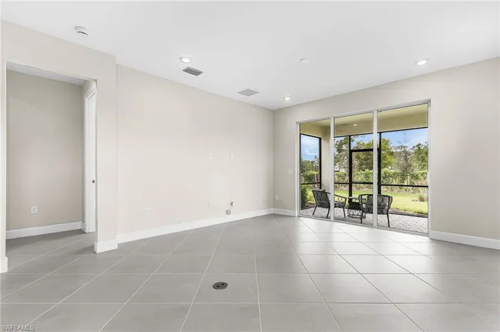 Empty room with light tile patterned flooring and recessed lighting
