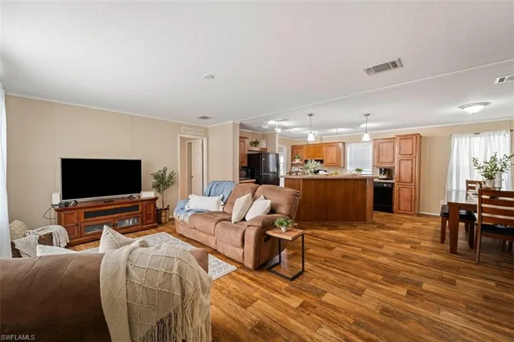 Living room with crown molding and hardwood / wood-style flooring